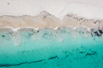 Fototapeta na wymiar Top-down drone capture of waves breaking on Mosman Beach in Perth, Western Australia 