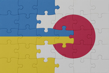 puzzle with the national flag of ukraine and japan . macro.concept.