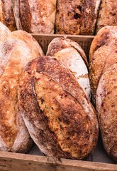 Vertical shot of fresh loaves of bread on the racks of a market