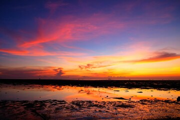 Naklejka na ściany i meble Stunning sunset with dramatic dark clouds over the sea in Ko Pha Ngan, Thailand
