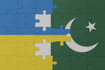 puzzle with the national flag of ukraine and pakistan . macro.concept.