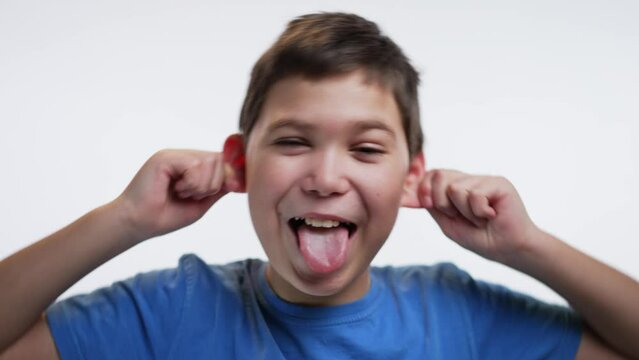 Kid making a face and showing his tongue