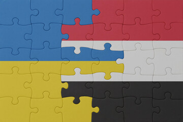 Fototapeta premium puzzle with the national flag of ukraine and yemen . macro.concept.