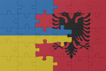 puzzle with the national flag of ukraine and albania . macro.concept.