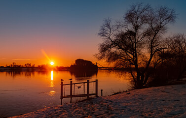 Fototapeta na wymiar Sunset with reflections near Metten, Danube, Bavaria, Germany