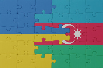 puzzle with the national flag of ukraine and azerbaijan . macro.concept.