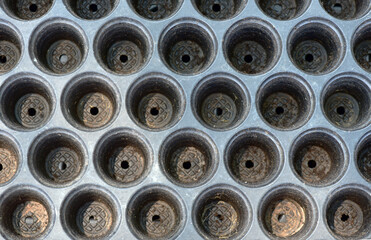 Obraz premium Black empty plastic tray with holes for separating seedlings background image