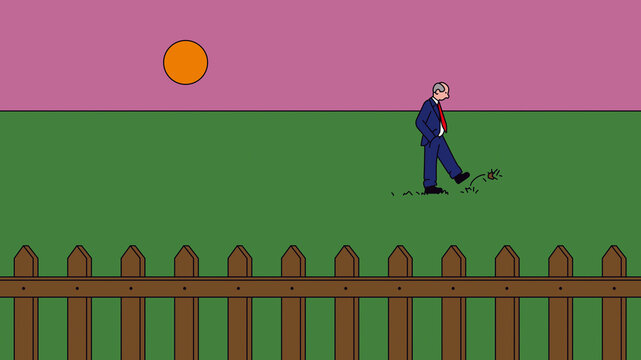 Man idle and alone in field behind fence 