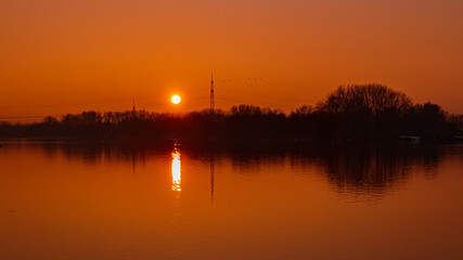 Fototapeta na wymiar Sunset with reflections near Plattling, Isar, Bavaria, Germany