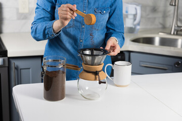 Fototapeta na wymiar Woman making a pour over coffee at home