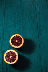 Fresh, juicy Sicilian orange cut in half on a blue background