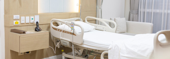 Female patient lying on an inpatient bed in the recovery room treating the illness and being closely monitored by a physician, Service point in a modern hospital