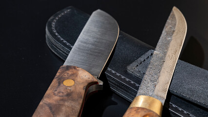 Damascus steel knives on a black background. Kitchen knives. background with japanese knife. A set...