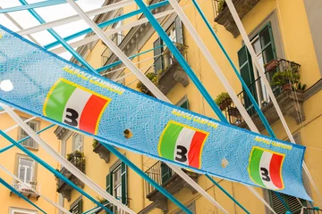 Wandcirkels tuinposter Flags of the Napoli football club displayed in the Spanish quarters, historic center of the city. The city of Naples, Italy, is celebrating its third championship in Serie A. © Stefano Tammaro