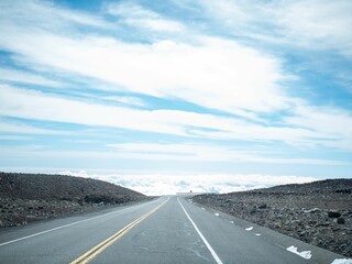 Scenic highway stretching through the vast desert against the cloudy sky