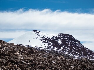 Stunning shot featuring a majestic mountain with a white blanket of snow draped across its peak