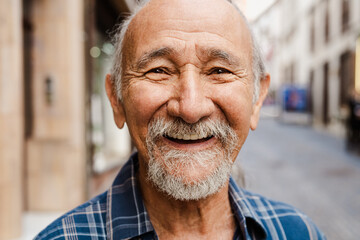 Portrait of happy senior man smiling in front of camera - Elderly people lifestyle concept - 595062092