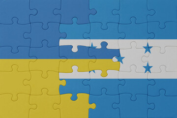 puzzle with the national flag of ukraine and honduras . macro.concept.