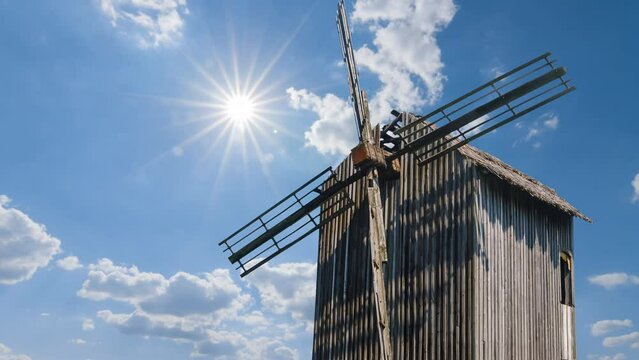  closeup winmill on sunny sky background, historical authentical scene time lapse scene