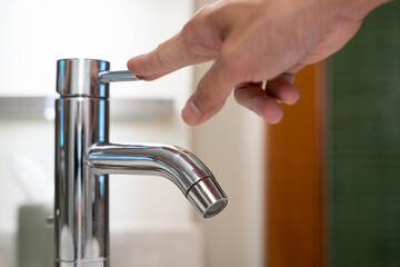 Save water. Volunteer keeps turning off the running water in the bathroom to protect environment. Greening planet, reduce global warming, Save world, life, future, risk energy, crisis , water day.