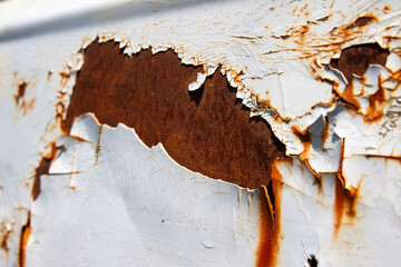 Rusted white painted metal wall. Rusty metal background with streaks of rust.