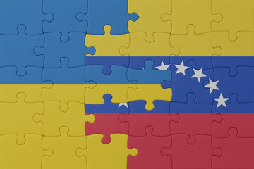puzzle with the national flag of ukraine and venezuela . macro.concept.