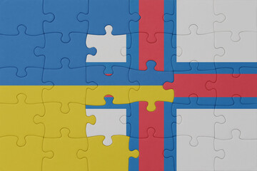 puzzle with the national flag of ukraine and faroe islands . macro.concept.