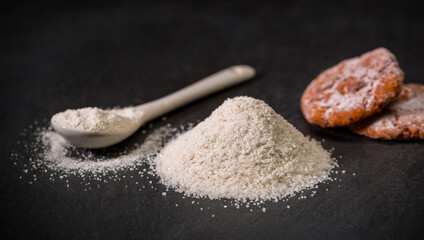 Spices for recipes. Viennese sugar. A spoon and a pile of sugar, salt or flour. Sweets. Ground spice