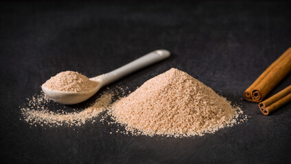 Cinnamon sugar. Spices for recipes. Spoon and pile of sugar and cinnamon. Sweets. Ground spice.