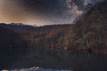 Beautiful night landscape. Bright Milky Way galaxy over the lake.
