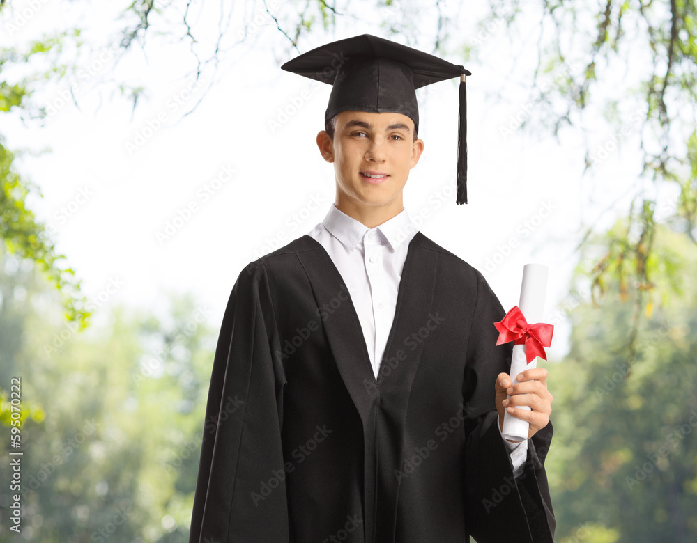 Wall mural Smiling male graduate student in a park