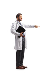 Young male doctor standing and pointing with a finger