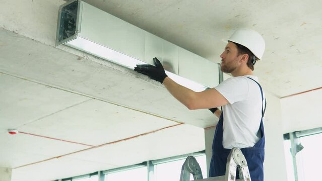 Hvac worker install ducted pipe system for ventilation and air conditioning