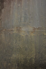 An old metal surface tarnished over time, with signs of weathering that have deteriorated the metal material. A dirty, dull gray color.