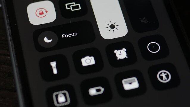 Kyiv, Ukraine April 15, 2023: Pressing a finger on the screen recording button on an iPhone. Screen recording on iPhone, close-up, horizontal video orientation