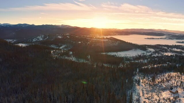 Aerial view of frozen Georgetown Lake, near Philipsburg, Montana at sunset. Anaconda range with Warren Peak dominates the background of the winterly landscape.