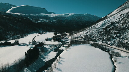 Aerial view of a small village in the mountains. Winter landscape.