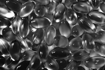 Grayscale shot of an arrangement of multiple capsules.