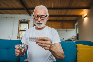 One man senior caucasian male hold medicine drugs tablet read label