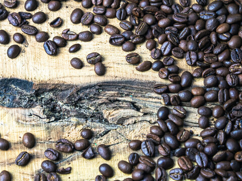 Coffee beans on wooden background. Close-up image. © Sergio