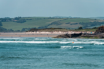 Fototapeta na wymiar The Irish are relaxing on the seashore near Clonakilty on a summer day. Inchydoney beach, sea.
