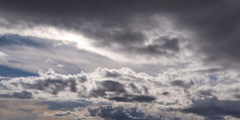 Gray cumulus clouds in the sky. Dramatic skies, landscape. The sky is like a background. White clouds and blue sky
