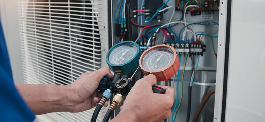 Technician is checking air conditioner,measuring equipment for filling air conditioners.