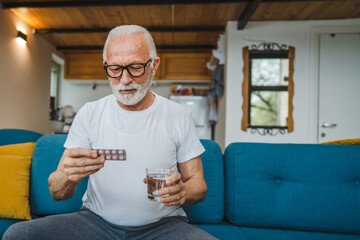 One man senior caucasian male hold medicine drugs tablet read label