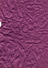 Purple crumpled sheet of tissue paper