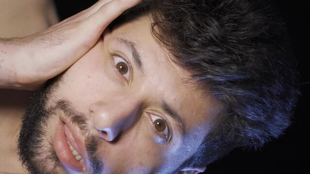 Vertical Video of Close portrait of schizophrenic man. Lunatic man.
Man with schizophrenia looking at camera. Having a mental disorder.
