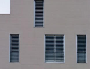 Grayish-brown textured wall with window blinds.