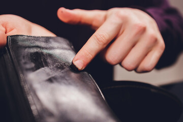boots. applying cream with your finger. Shoe repair.