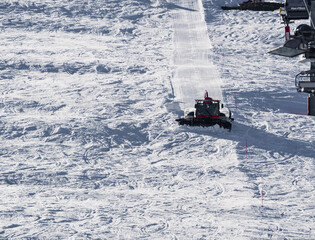 Snowcat, ratrack - machine for snow preparation while working in Alpe D'huez - One of the most popular ski resorts in the Alps in France