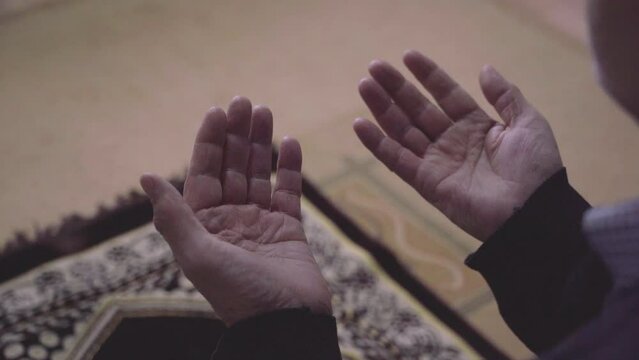 Close up praying human hand, image of a muslim person praying